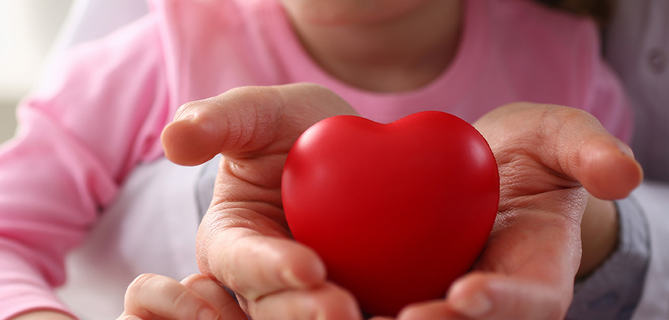 Heart in hand with child