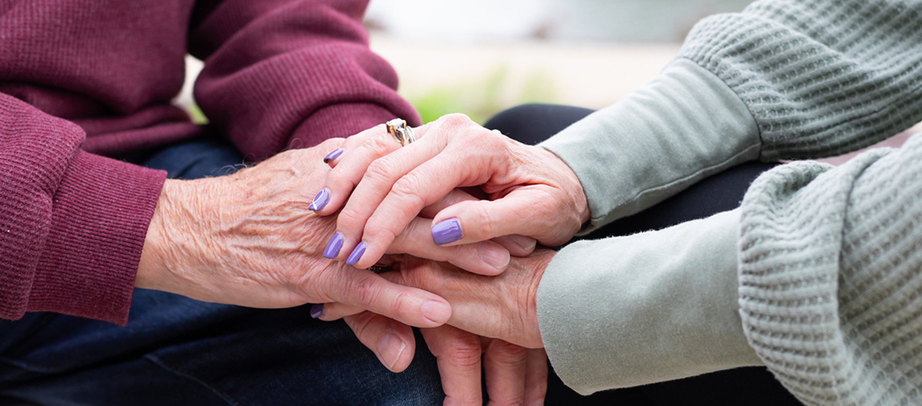 Grief support counselor covering hands