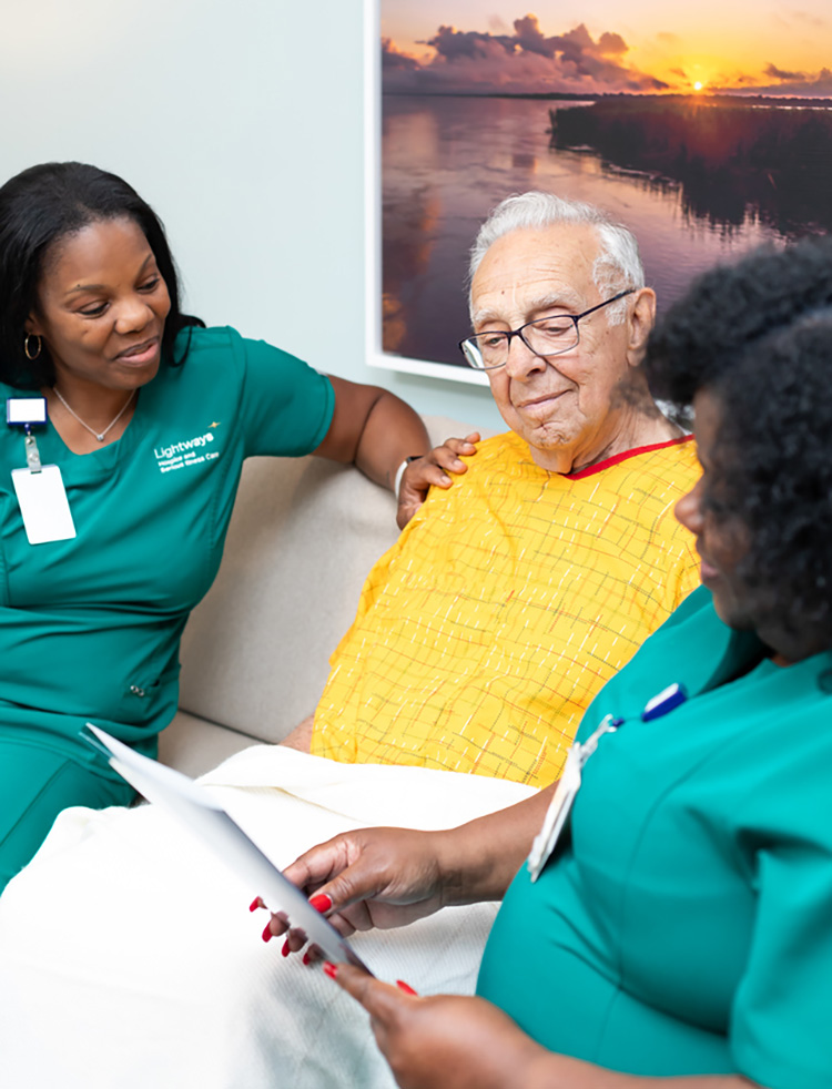 Lightways nurses with male patient reviewing paperwork