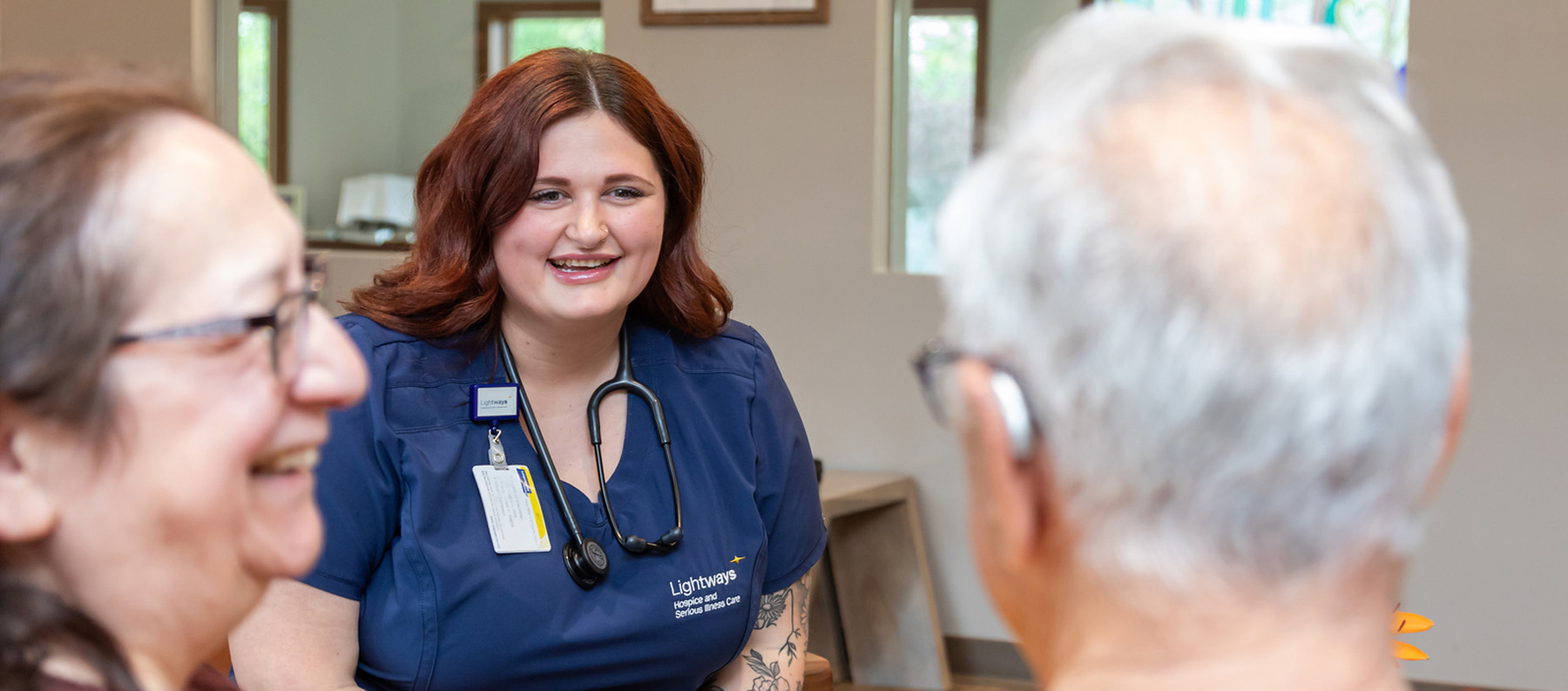 Lightways Nurse sitting and talking with wife and husband at Lightways Hospice Joliet