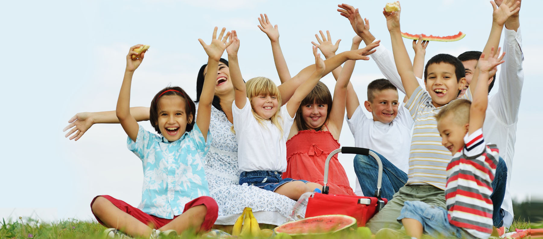 Group of children with hands in the air.