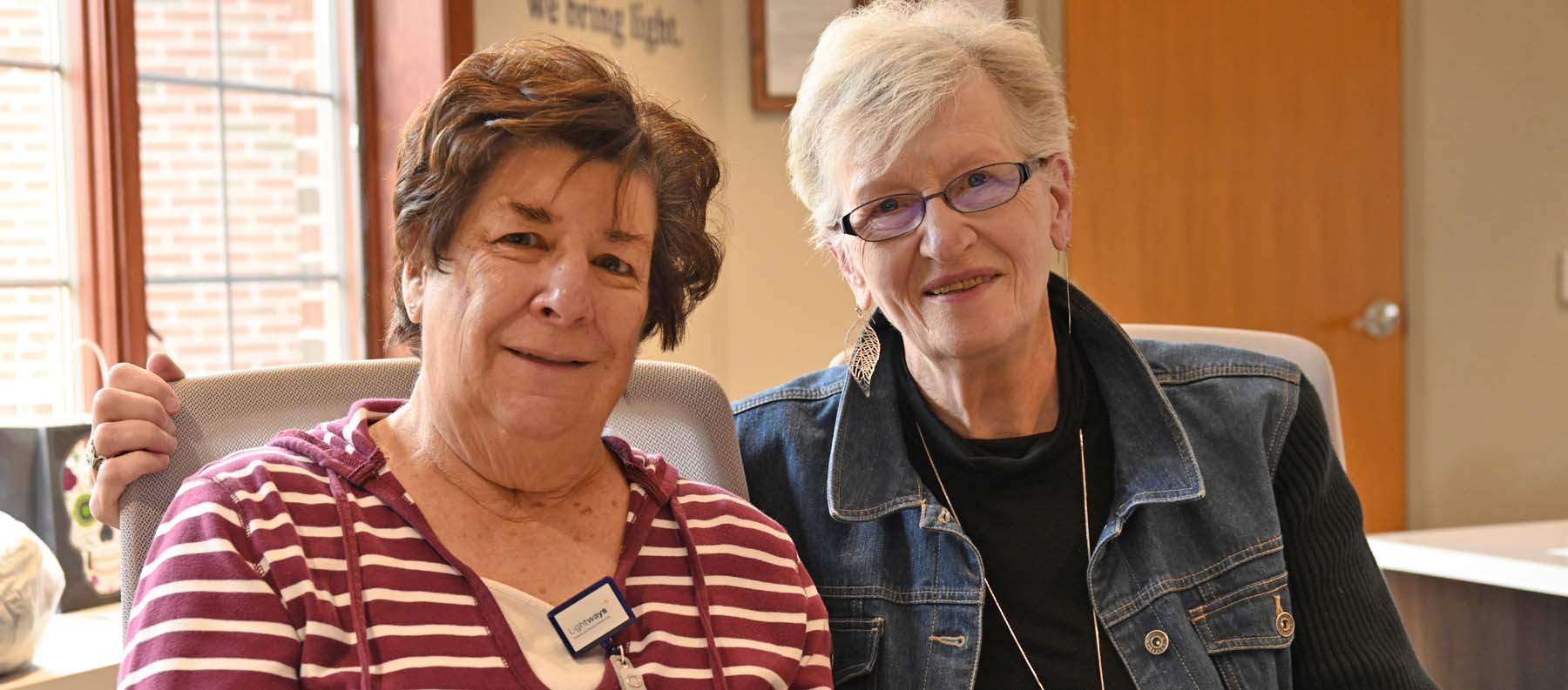 Two volunteers pose for photo.