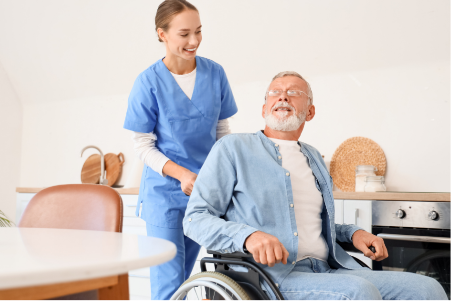 Palliative and ALS Nurse pushing elderly man in wheelchair