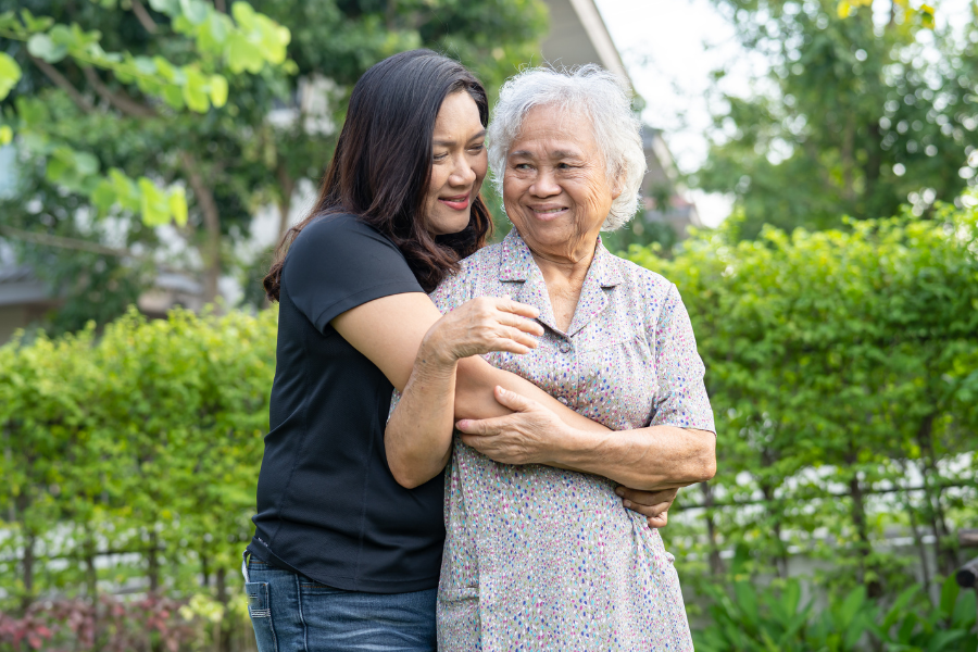 Palliative and myths Daughter hugging elder mother outdoors