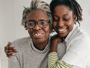 mom-daughter-caregiver Mom and daughter hugging and smiling
